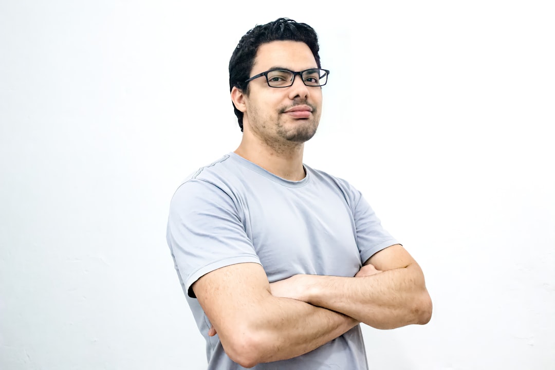 Photo by Jonas Kakaroto man in white crew neck t-shirt wearing black framed eyeglasses